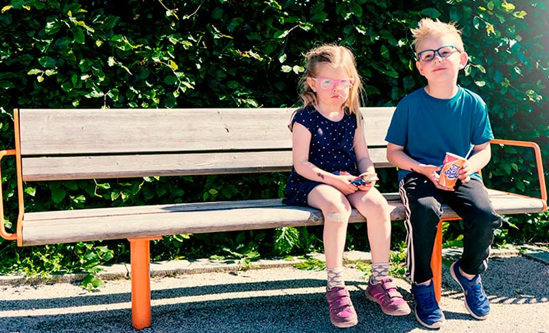 to barn med briller på en benk