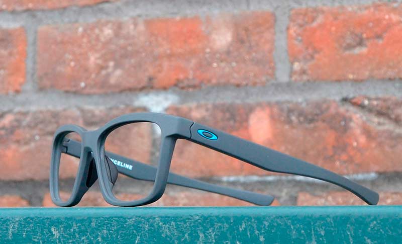 glasses on a board with a brick wall in the background
